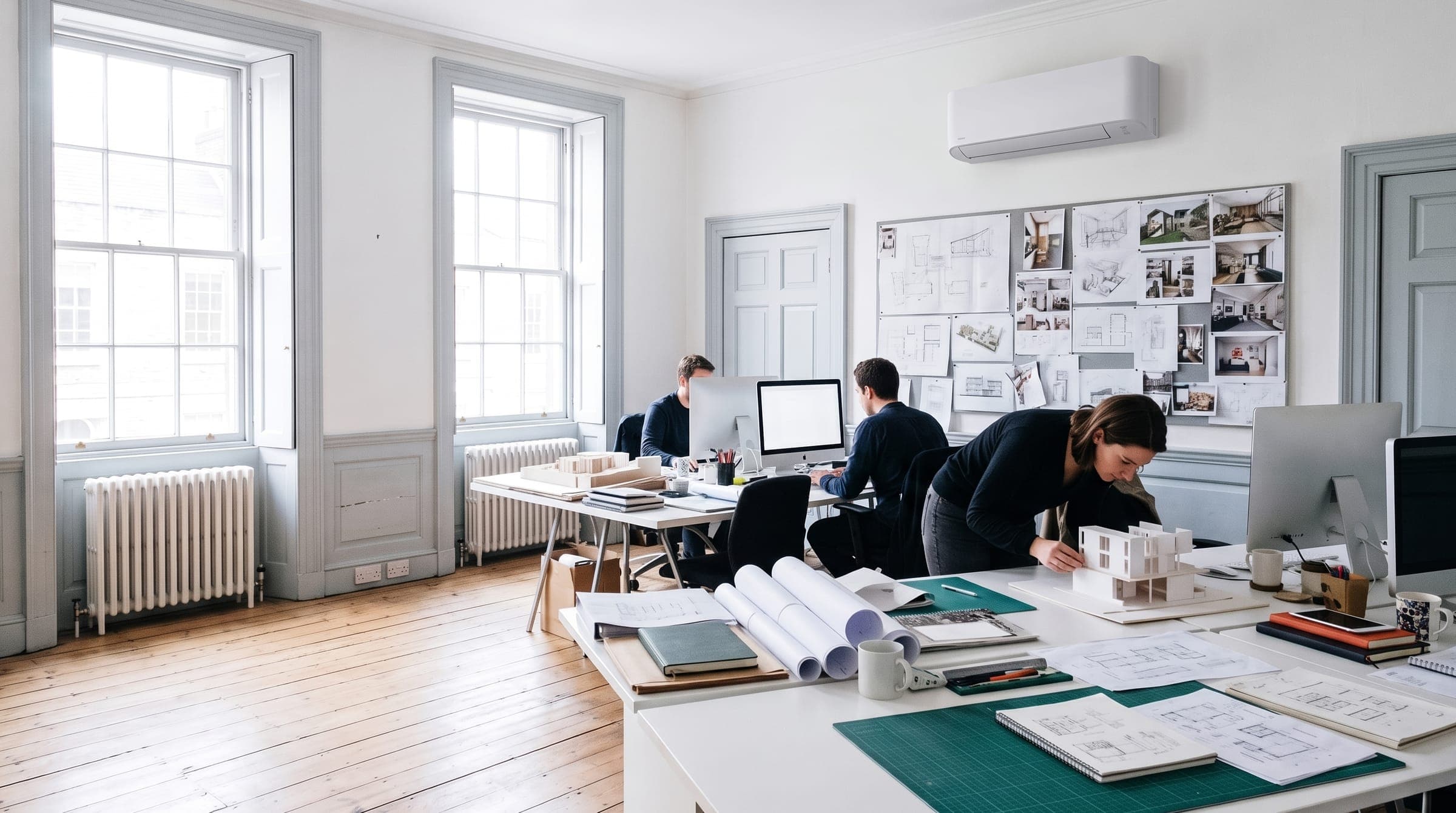 Small architecture studio in a Georgian townhouse with a white air conditioning unit high on the wall